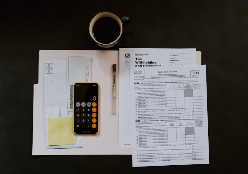 Professional accounting workspace with calculator, documents, and financial reports